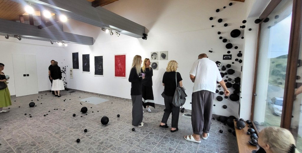 Exhibition View - audience near stratified pink exhibition archive Roxana Donaldson, 2025